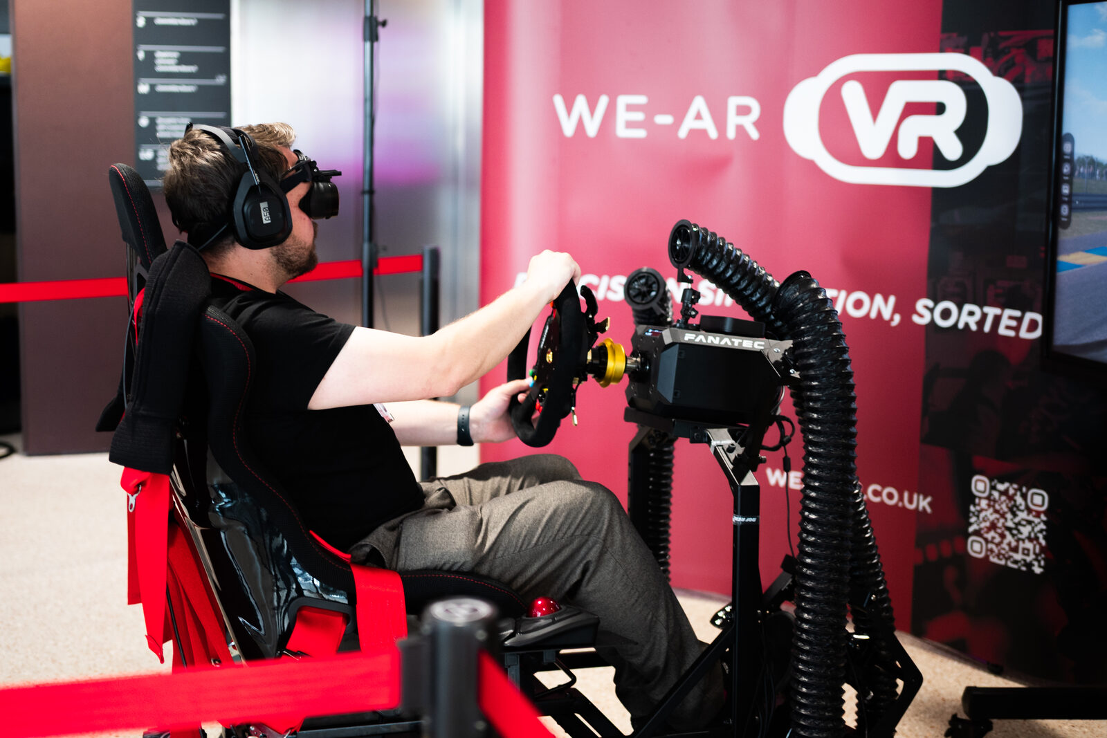 Driver in a VR headset on the WE-AR VR rig at City Hall